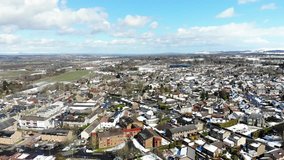 Aerial drone footage of suburban houses after snowy winter morning 