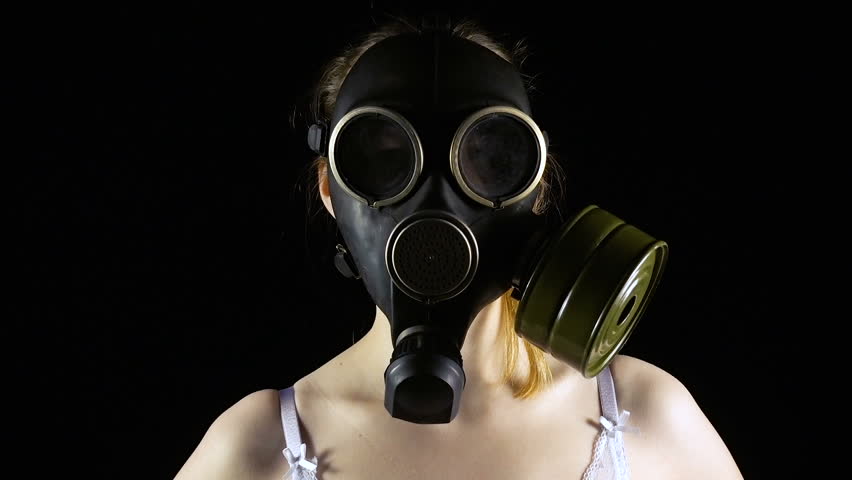 Young woman in gas mask