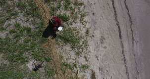 Drone Remote Controller, Hand and remote view of drone pilot operator in helmet, river sand