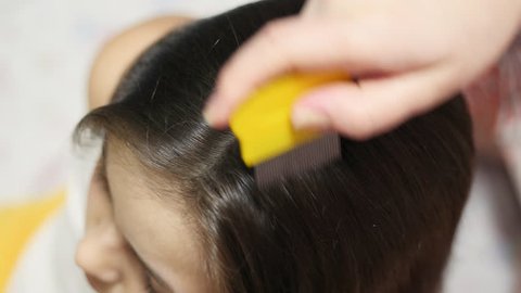 Top view Mother treating daughter's hair against lice
