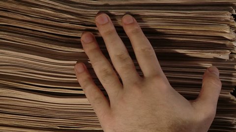 Hand with a bunch of newspaper