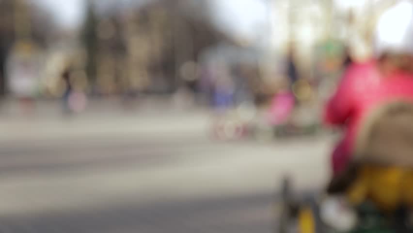 Little girl riding a small car on the playground