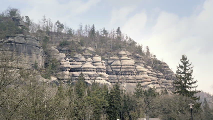 Sandstone rocks, rock massifs in forest. Climbing landscape in Germany, big stones. Outdoor travel destination. Static day stabilized v-log shot, overall view.