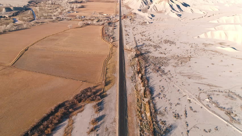 Aerial view of car driving on highway 24 through the Caineville desert in Utah.