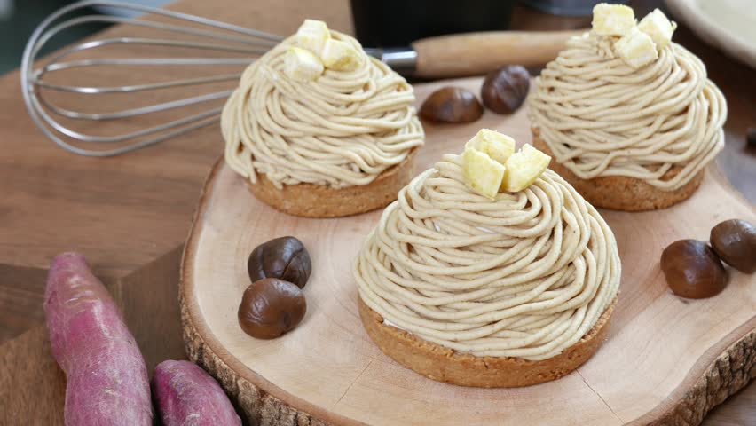 Mont Blanc Dessert or Chestnut Cream cake a dessert filled mostly with whipped cream. set on wooden table