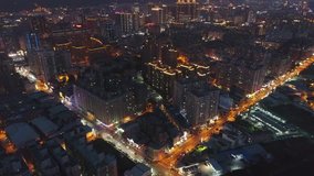 Aerial Shot of Taoyuan City Skyline at Night - Cityscape birds eye view use the drone, shot in Taoyuan, Taiwan.