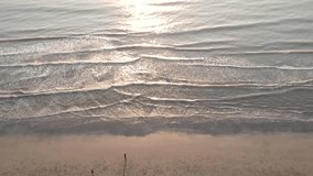 Tropical beach video loop showing seamless never ending footage with aerial bird eye view of green foaming ocean waves crushing.