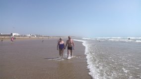 
High quality video of lovely senior couple walking by the beach in real 1080p slow motion 250fps