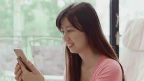 video of woman use phone and smile happily