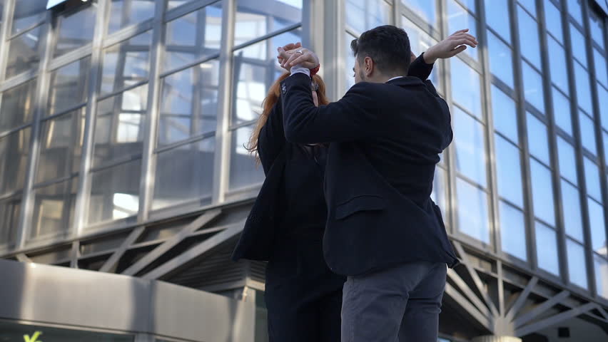 Happy succesful collegues hugging in the street- Teamwork,collaboration,business