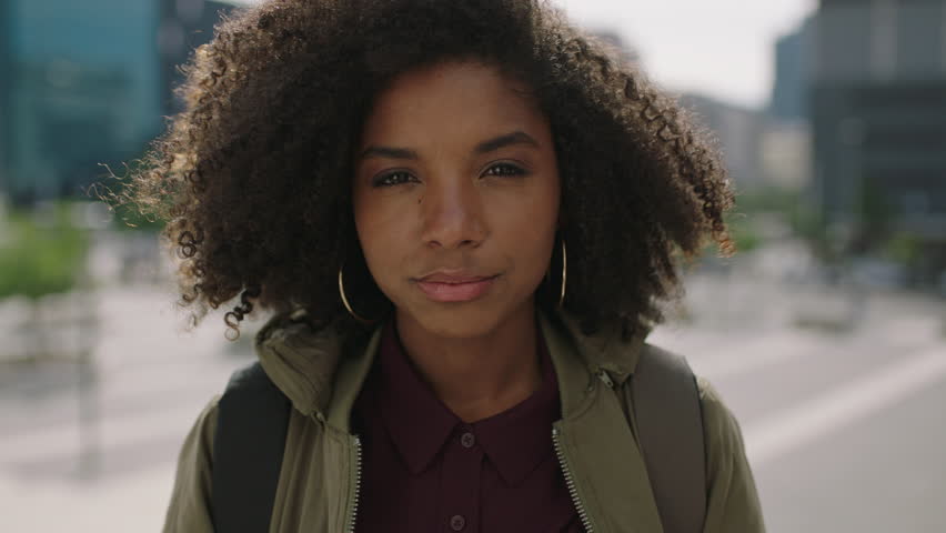 portrait of young trendy african american woman student with afro hairstyle smiling happy enjoying urban lifestyle in city real people series Royalty-Free Stock Footage #1009537853