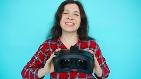 Young woman offers to wear glasses virtual reality, VR goggles, VR-headset glasses