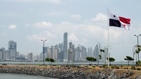 Panama City, Panama - march 2018: National flag of Panama with skyline of Panama City in background