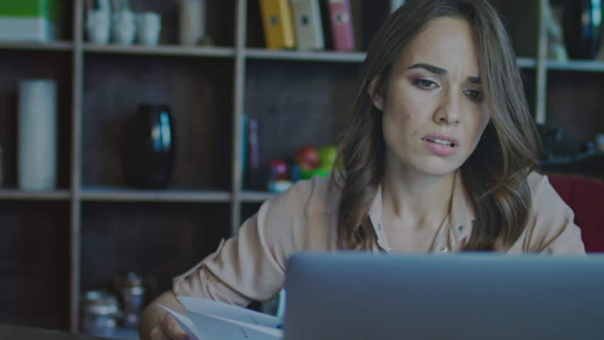 Worried business woman face looking at laptop in office. Close up of upset businesswoman thinking about mistakes in work. Portrait of sad girl looking laptop. Depressed employee working on laptop | Shutterstock HD Video #1009561580