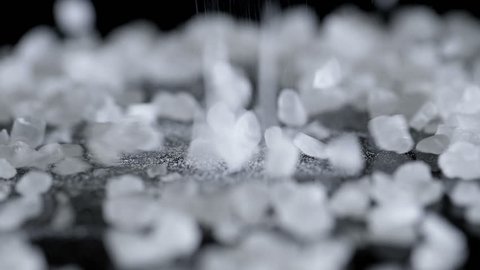 Close up of sea salt. Sea salt pouring in slow motion.
