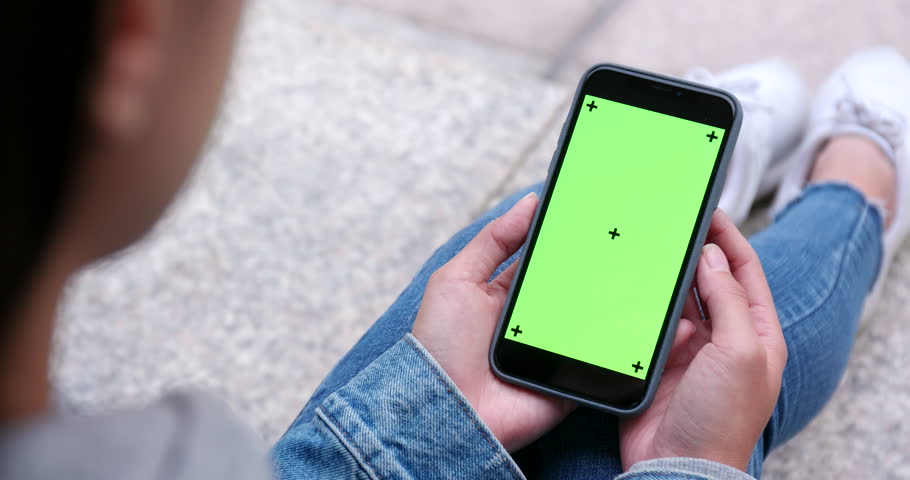 Woman use of mobile phone with green screen, chroma key