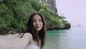 Girl tourist taking selfie photograph on Asia beach islands, women enjoying Asian summer holiday travel vacation adventure. 