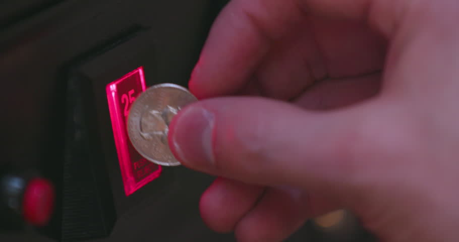 Inserting Quarter Into 25 Cent Arcade Machine Coin Slot | Shutterstock HD Video #1009582790