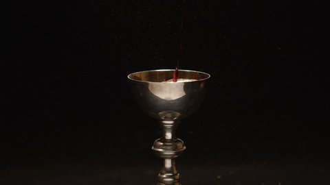 Chalice full of wine slow motion pour