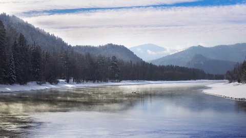 Mist above the Snowy Mountain River in Winter Morning