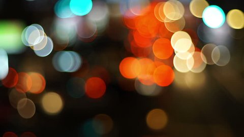 Abstract blur, de-focus of moving vehicles bokeh traffic lights on a busy street at night time