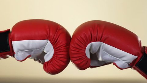 Two opponents hands in boxing gloves, sport competition, resistance, conflict