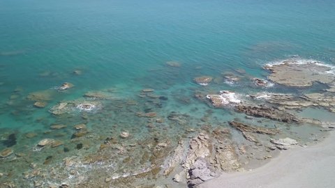Aerial view of the cliff with rocks on the blue sea.