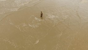 aerial footage from Another Place Crosby on the northwest coastline with iron statue in the sand