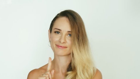 Adult woman showing gesture finger moving side to side for expressing no in white background. Portrait woman showing gesture no close up
