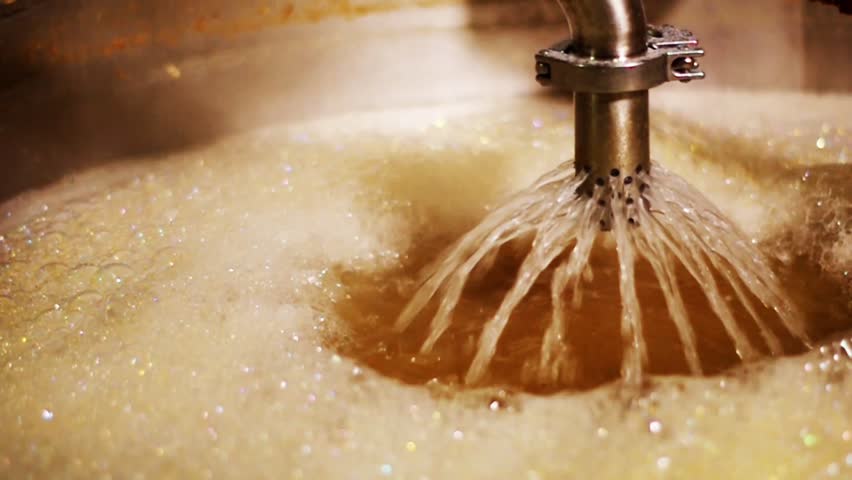 Closeup boiling hot liquid filtering during beer brewing process | Shutterstock HD Video #1009614998