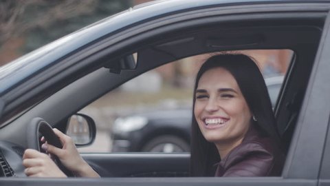 cheerful woman laughing and fooling around in the car