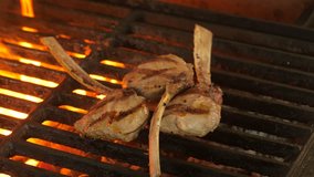 Three fried mutton stand or veal with vegetables, food for restaurants, close-up video, cooking process, chef turns the meat with grilled meat