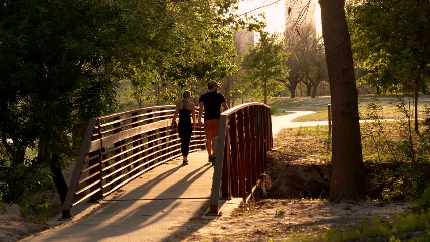 Couple in Park in Houston at Sunset Tracking Shot Royalty-Free Stock Footage #1009625453