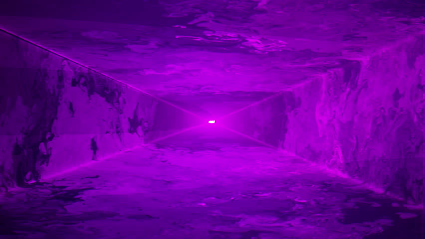 A purple laser light tunnel with swirling smoke shines through an empty room. Nightclub/concert/music festival. Abstract laser light tunnel background plate. Alpha matte.