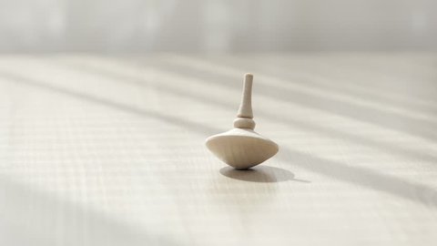 Wooden spinning top on a table. Closeup
