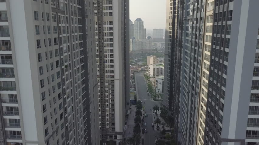 Aerial view of Ho Chi Minh City Saigon, Vietnam 2018: Fly through Vinhomes disctrict buildings with a drone in an amazing cinematic video style during dusk, dawn and sunset. 4K resolution.