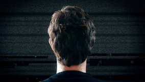 TV Noise Interference Video Glitch, Man Watching Television. Young man watching big screen television with static noise glitch. Shot behind model shoulders. - Powered by Shutterstock - Get 15% off with code: PIKWIZARD15