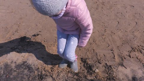 Little girl jumping on sand