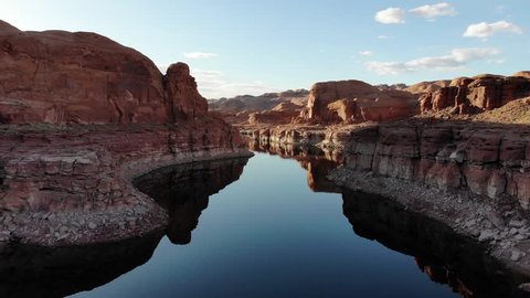 A beautiful clip of a perfect red sandstone reflection on Lake Powell within Glen Canyon National Park. The water is calm and still with cliffs rising straight from the water. An amazing destination.