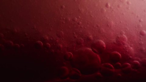 Bubbles surging and pumping; red color reminiscent of blood and plasma fluids.