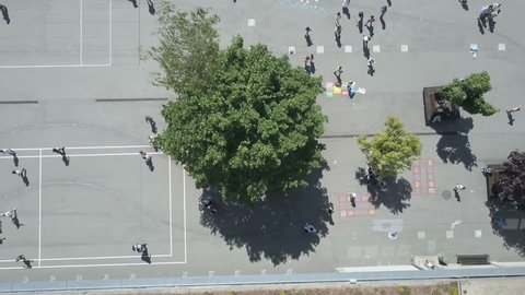 Kids playing in school playground during lunch break, Aerial Overhead Shot