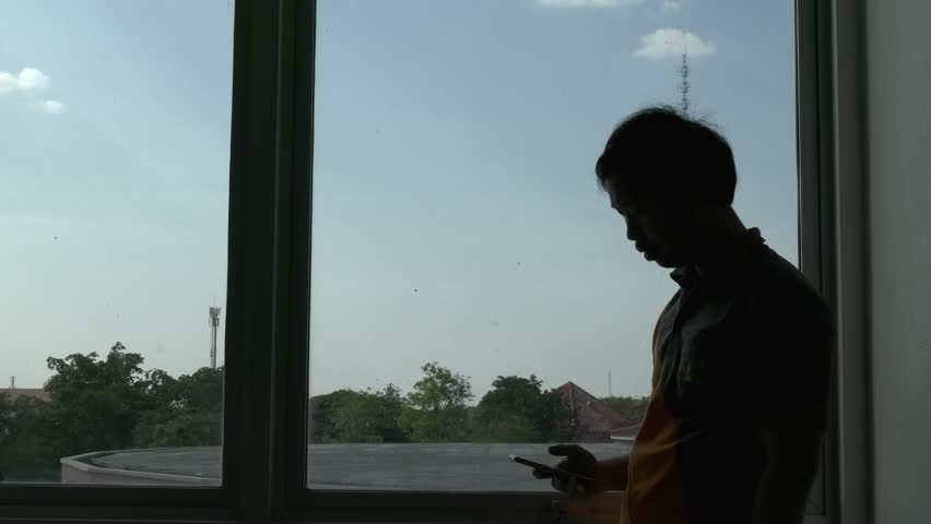 Silhouette of asian handsome man talk telephone