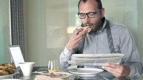Young businessman eating breakfast and reading newspaper by table at home
 - Powered by Shutterstock - Get 15% off with code: PIKWIZARD15