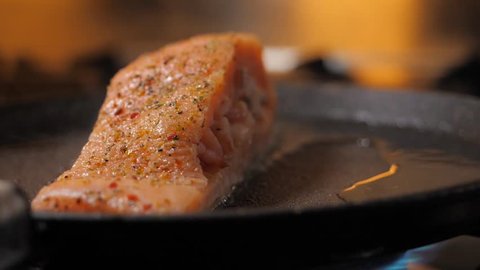 Pan-fried Salmon. Cooking salmon in a pan. Salmon stuffed with shrimps on a pan.
