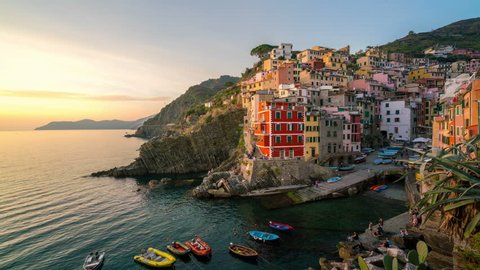 Sunset time lapse of Riomaggiore in Italy - Riomaggiore is a traditional fishing village in La Spezia, situated in valley in Liguria of Italy. Riomaggiore is one of Cinque Terre travel village.