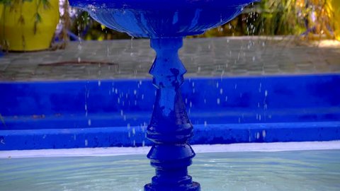 Blue fountain in Majorelle Garden. Marrakech, Morocco. Slow motion shot.