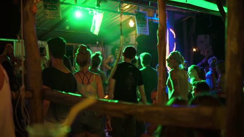 KOH PHANGAN - CIRCA 2018: People dancing at reggae concert in small cozy bar. Party