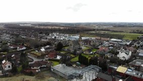 Aerial drone footage of suburban houses and fields in Scotland, UK