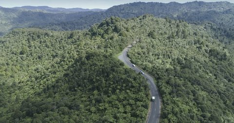 Aerial: flying over the cars on the road in waitakere ranges of Auckland, New Zealand