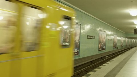 August, 2017 Berlin, Germany, metro station Alexanderplatz in Berlin while a yellow metro is leaving the station